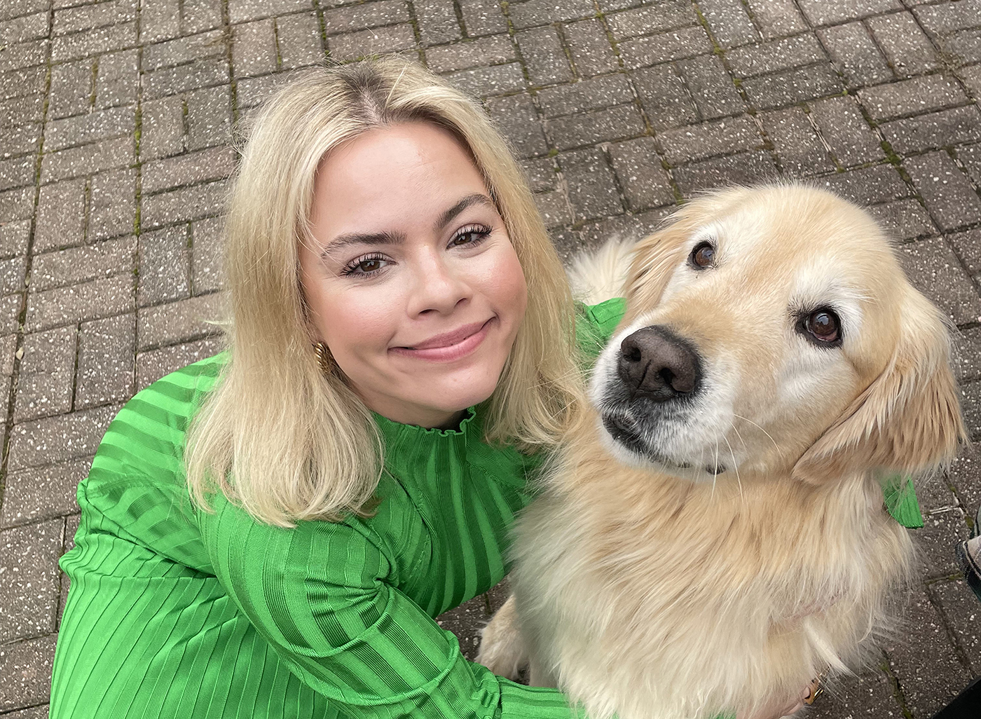 Amy Evans poses with her golden retriever, Teddy.