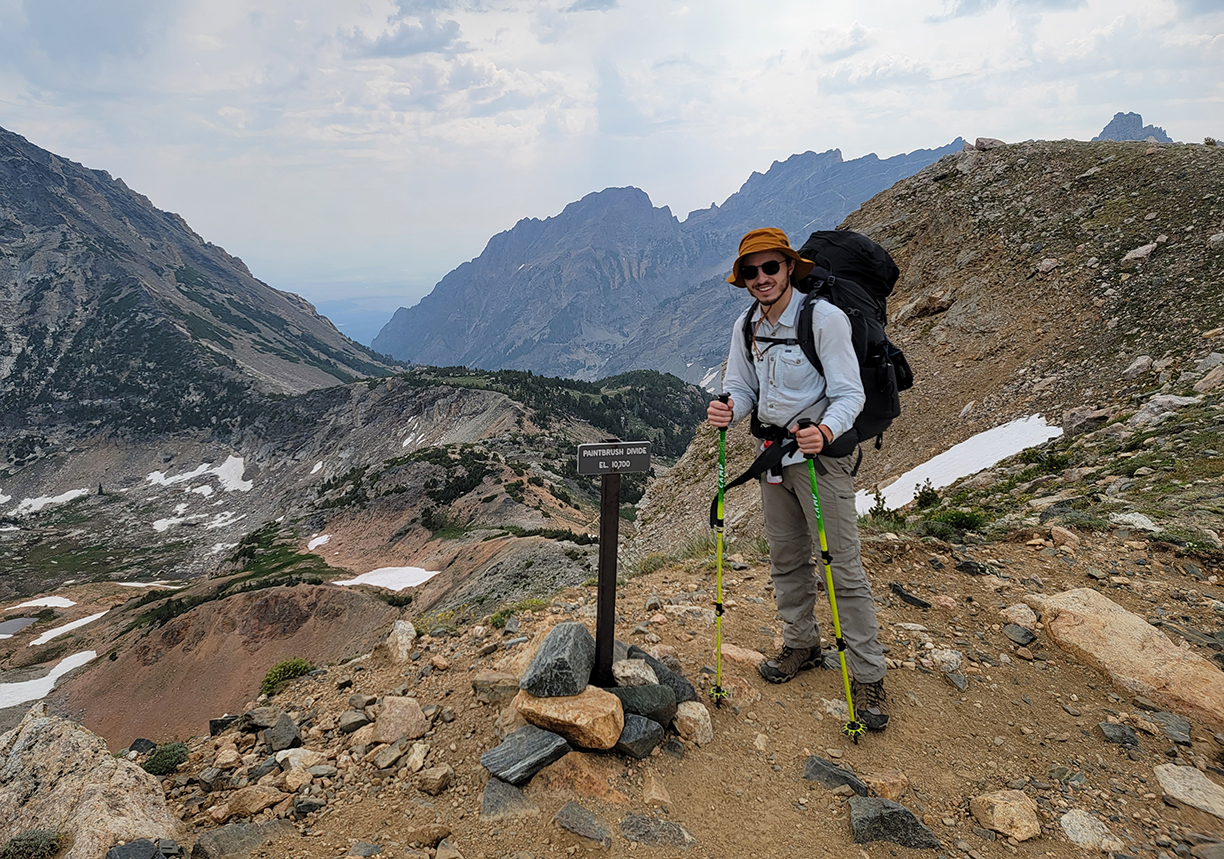 Brayden Richardson posing at the top of Paintbrush Divide.
