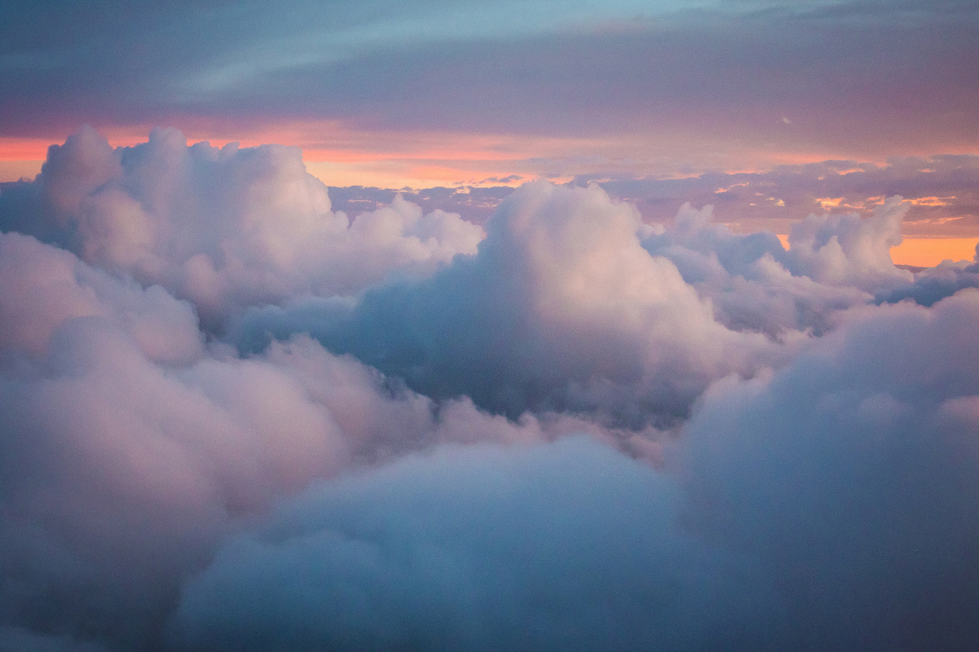 Gray clouds in front of a sunset sky.