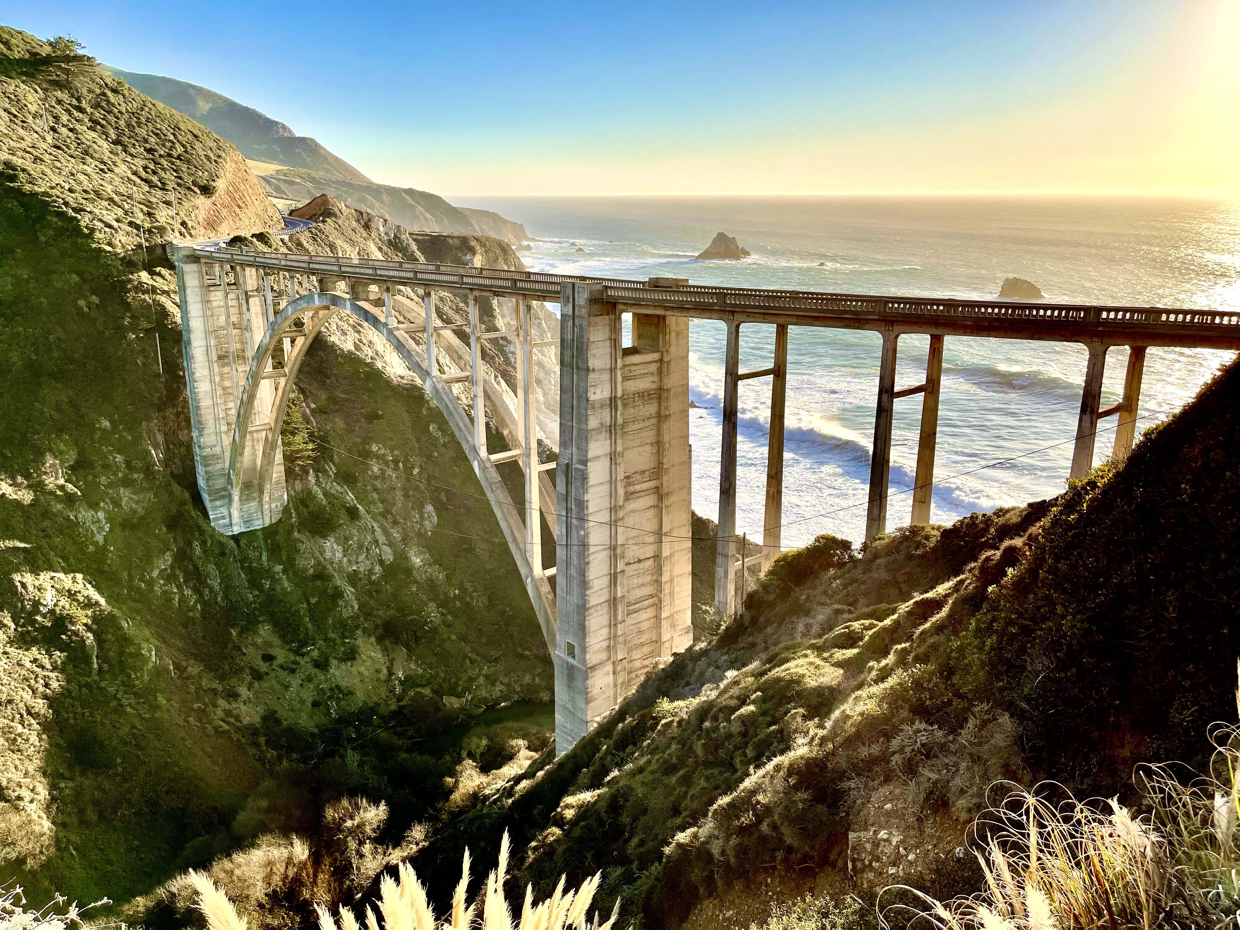 Bridge between two mountains, overlooking the beach shore.