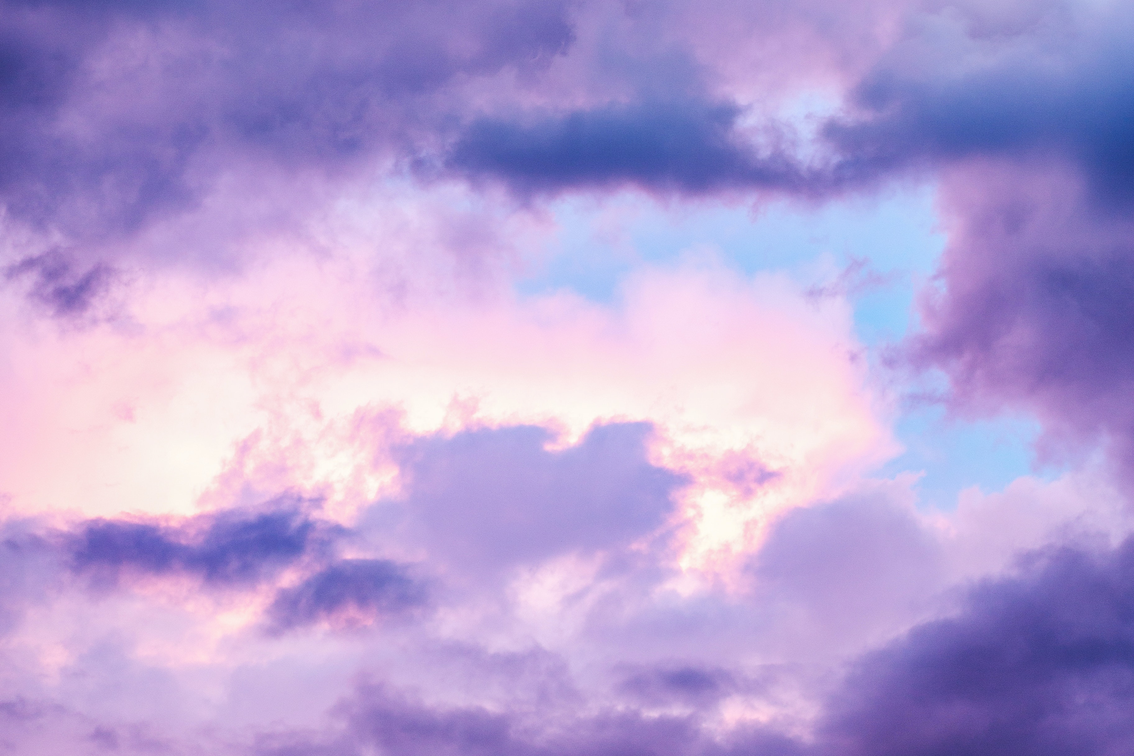 Purple-hued clouds against a blue sky.