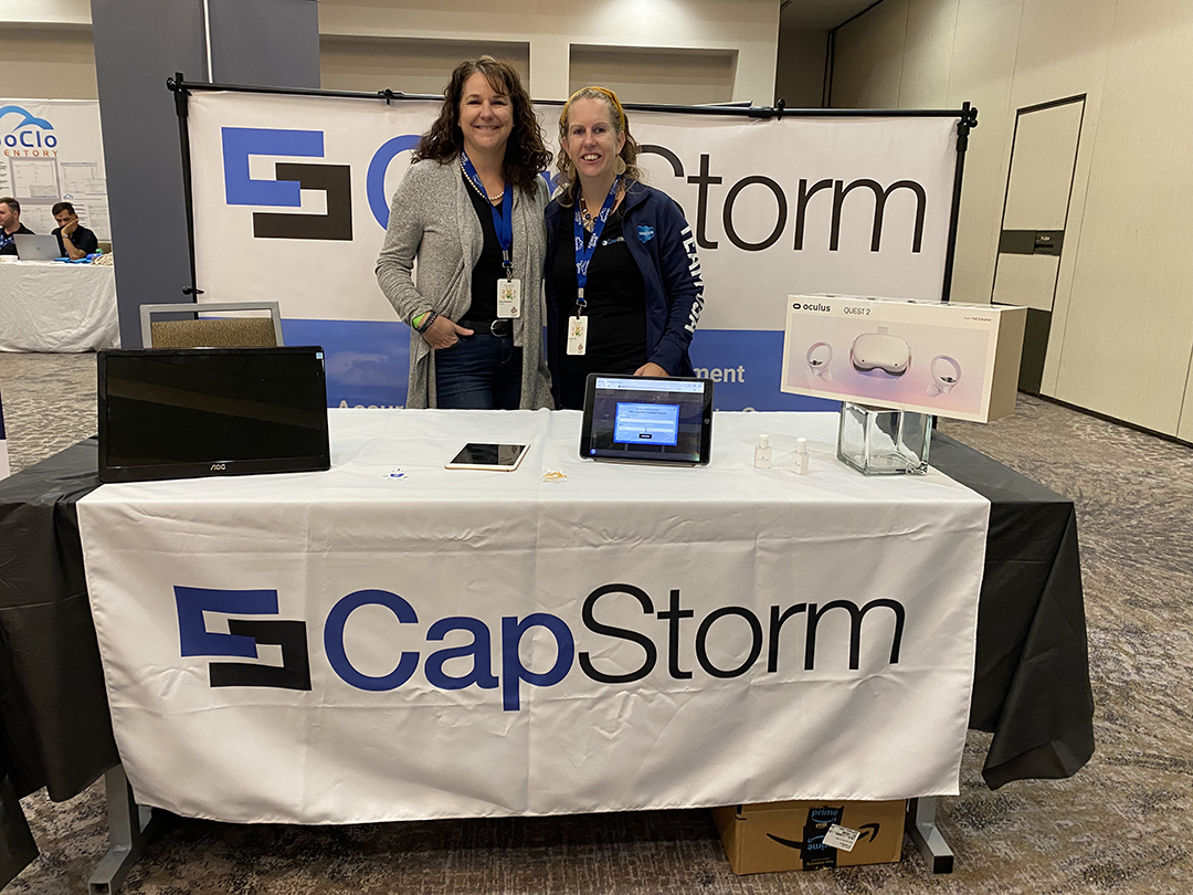 Sharon Steingruber and Rebecca gray pose at the CapStorm booth during the Texas Dreamin' conference.