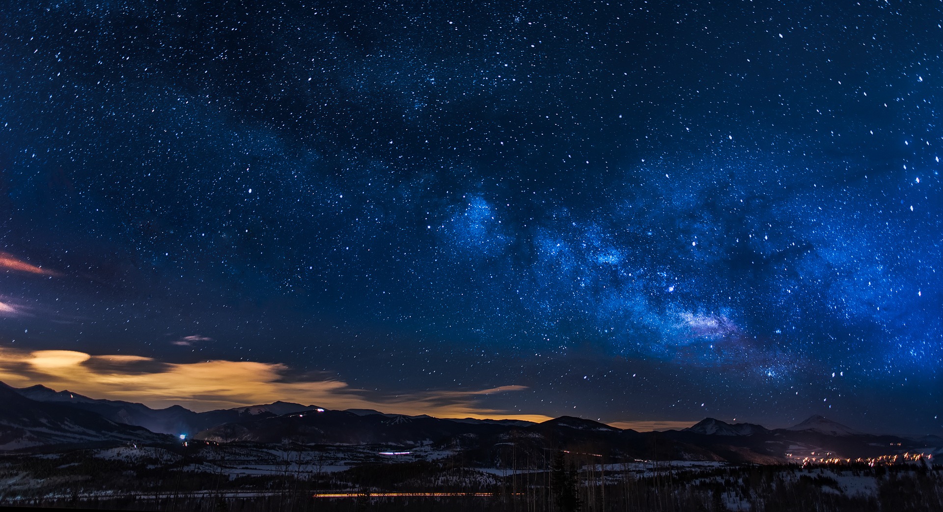 Night sky with stars overlooking Colorado mountains.