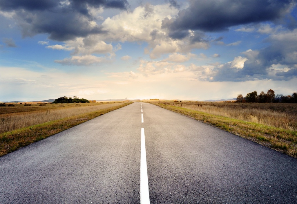 Country road with cloud sky.